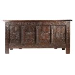 A Charles II oak coffer, Yorkshire, circa 1660 The front of four panels, each carved with a stylised