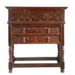 A Charles II oak boarded box on frame, with drawers The box with anthemion strapwork carved friezes,