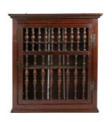 A William & Mary oak spindle-filled mural cupboard, circa 1700 Having a moulded cornice and bead-