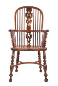 A Victorian yew high-back Windsor armchair, North East Yorkshire, circa 1840-70 The hooped back with