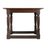 A Charles I oak centre table, circa 1630 Having a boarded and end-cleated top, and channel run-