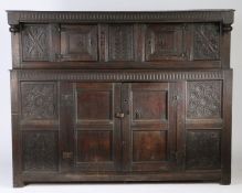 A Charles II oak court cupboard, circa 1660 Having a slender nulled-carved frieze with end-pendants,