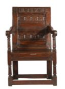 A Charles II oak panel-back open armchair, dated '72' The back of two horizontal panels, each boldly