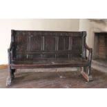 An exceptionally rare and interesting mid-16th century joined oak settle, English, circa 1540-80 The