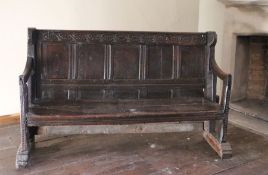 An exceptionally rare and interesting mid-16th century joined oak settle, English, circa 1540-80 The