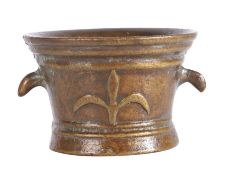 A 17th century style bronze mortar, probably French Cast with a fleur-de-lys, twice, and with two
