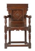 A good Elizabeth I joined oak panel-back open armchair, West Country, circa 1600 The back panel