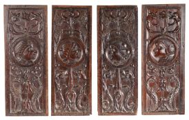 A set of four carved oak Romayne-type panels, French, circa 1520-40 Each with a portrait roundel,