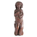 A late 16th/early 17th century carved oak figure of Hope Designed standing, holding an anchor,