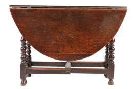 A Charles II oak gateleg table, circa 1680 Having an oval drop-leaf top, on simple gates, with