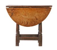 A rare Charles II oak stool-table, circa 1680  The oval top with two leaves supported on extending