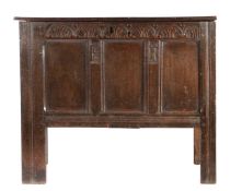 A small Charles I joined oak coffer, circa 1630 Having a boarded hinged lid, the front with three