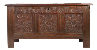 A Charles I oak coffer, West Country, circa 1640 Having a triple panelled lid, the front also with
