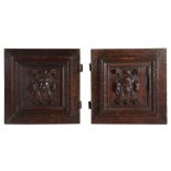 A pair of Elizabeth I carved oak boarded cupboard doors, circa 1570 Each carved with a figural