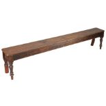 A Victorian pine bench, circa 1860 and later Having a one-piece top, plain rails and inverted-