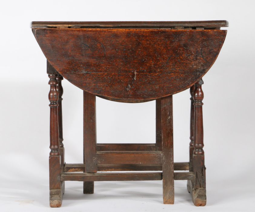 A William & Mary oak gateleg occasional table, circa 1690 Having an oval drop-leaf top formed from