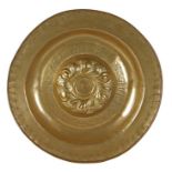 A large brass 16th century alms dish, Nuremberg, circa 1500-1550 Centred by a raised boss with a