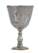 An 18th century miniature tinned latten chalice, English Having a large plain cup on a baluster