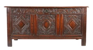 A Charles II oak coffer, Yorkshire, circa 1670 Having a boarded top with ovolo-moulded edge, the