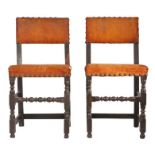 A pair of Charles II oak and hide upholstered chairs, circa 1670 Each with rectangular padded open