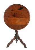 A William & Mary oak tripod table, circa 1700, The circular top with ovolo-moulded edge, tilting on