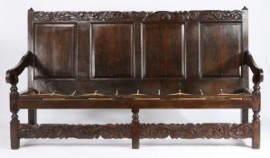 A Charles II oak settle, Cheshire/Lancashire, circa 1670 The rectangular back of four fielded