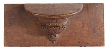 A 15th/16th century oak misericord, French Carved with a gadrooned 'urn' below a demi-circular