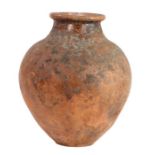 A 19th century or possibly earlier terracotta urn Of globular ovoid form, with glared neck, possibly