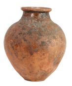 A 19th century or possibly earlier terracotta urn Of globular ovoid form, with glared neck, possibly