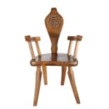 G B Pegg (British, 20th Century) Country Oak Armchair, the back carved with Tudor rose and the