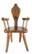 G B Pegg (British, 20th Century) Country Oak Armchair, the back carved with Tudor rose and the