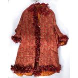 A late 19th century Norwich style red ground Paisley pattern housecoat, in machine made wool,