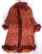 A late 19th century Norwich style red ground Paisley pattern housecoat, in machine made wool,