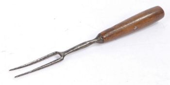 A primitive 18th two prong fork, with a steel prong and turned handle, 18.5cm long -UPSTAIRS