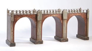 A unusual large model of a railway bridge, with a paved effect top with railings above the three