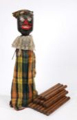 19th Century Aunt Sally, with carved black painted face, wearing a tartan outfit, 78 cm high,