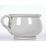 A Victorian pottery vomit pot, glazed in white with a loop handle and bulbous body, 13cm wide, 9cm