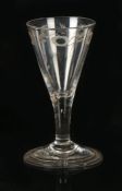 An 18th Century wine glass, the glass of trumpet shape bowl with engraved foliate decoration above a