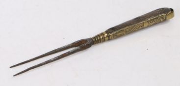An early 18th Century dated two pronged fork, with steel prongs and an wooden handle either side