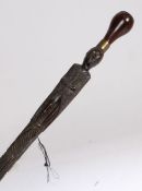 A good 19th Century Maori walking/Greeting Stick, New Zealand, finely carved figure with mother of