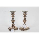 Pair of Victorian silver plated candlesticks, with a gadrooned and tapered body set on a gadrooned