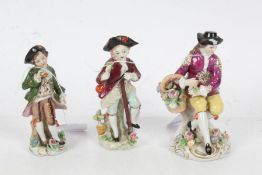Three Sitzendorf porcelain figures in 18th century dress, one depicting a young girl with a basket