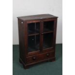 20th century oak glazed display cabinet/bookcase, with a pair of glazed doors enclosing a single