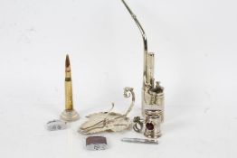 Mixed works of art, to include a Chinese white metal opium pipe, three Ronson lighters, a brass