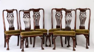 A set of six George III cherry wood dining chairs, the scroll undulating top rail above a wide