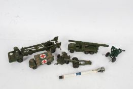Three Dinky Toys military vehicles, to include a Military Ambulance 626 and a Missile Erector,