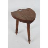 Small oak three legged stool, with shield shaped seat, 34cm high