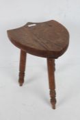 Small oak three legged stool, with shield shaped seat, 34cm high