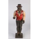 Standing carved figure modelled as a gentleman with black bowler hat, red waistcoat with black