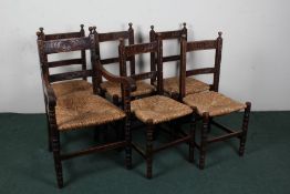 Set of six oak and rush seated chairs, with foliate carved back bars and rails, raised on ring